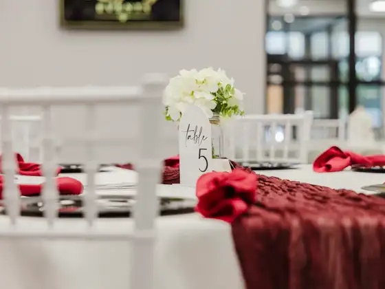 Table set for dinner service with a floral centrepiece and table number