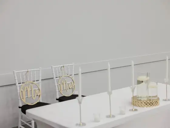Mr and Mrs signs on chairs at a candlelit head table