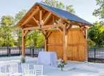 Ceremony chairs and floral arrangements in front of the timber pavilion